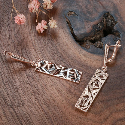 Tessa - Rosegullbelagte lange øredobber med elegant hult anhengsdesign