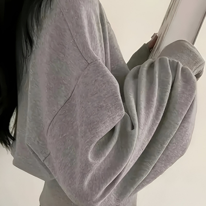 Nora – Bluse med rund hals, lange ermer og knappdetaljer