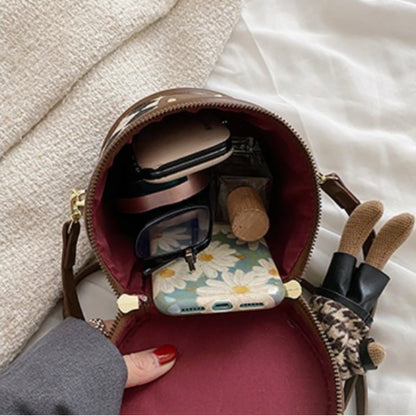 Charlotte - Rundformet håndveske med avtakbar stropp og kanin sjarm